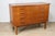 A 1960s Scandinavian chest of drawers in teak veneer, characterized by its clean lines and functional design. It rests on...