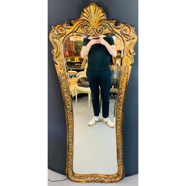 A stylish and elegant tall wall or depressing mirror in Regency style. The mirror is beautifully hand carved of gilded...