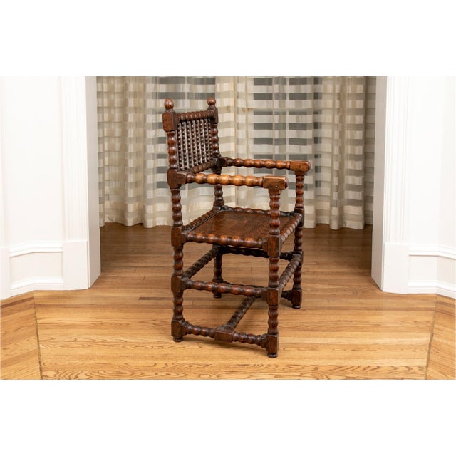 Antique bobbin-turned oak armchair in a dark stain with gorgeous patina, ball finials, vertical bobbin spindles, turned...
