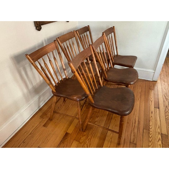 An antique set of six arrowback Windsor dining chairs with single plank seats. Unmarked by maker. Half the chairs differ...