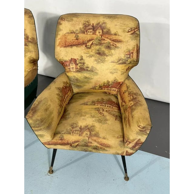 Vintage condition with original fabric for this set of two armchairs produced in Italy during the 1950s. They mount brass...