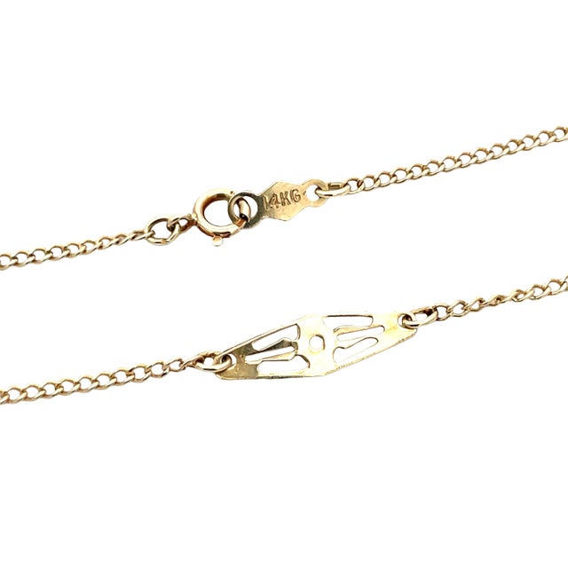 Delicate vintage chain necklace crafted in solid 14K yellow gold, featuring elegant filigree panel stations. Stamped 14K....
