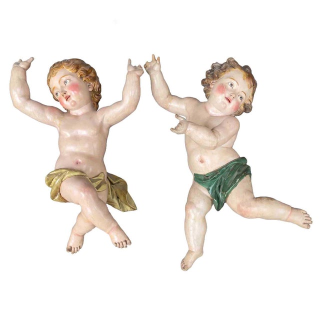 A pair of 17th-century Baroque cherubs in carved and lacquered wood, typical of Italian Baroque sacred art. They are two...