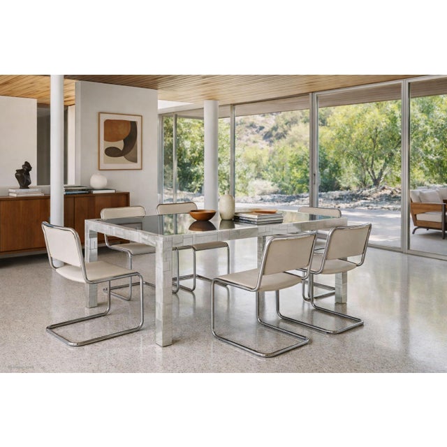 Step into a world where art and function merge with this remarkable mid-century dining table, designed by the legendary...