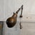 This mid 20th century industrial articulating task lamp features a brushed steel finish with a perfect work-worn patina....