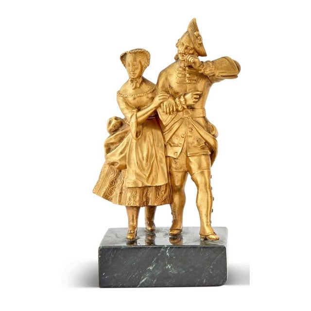 This charming pair of French gilt-bronze figural groups depicts courting couples elegantly dressed in 18th-century attire,...