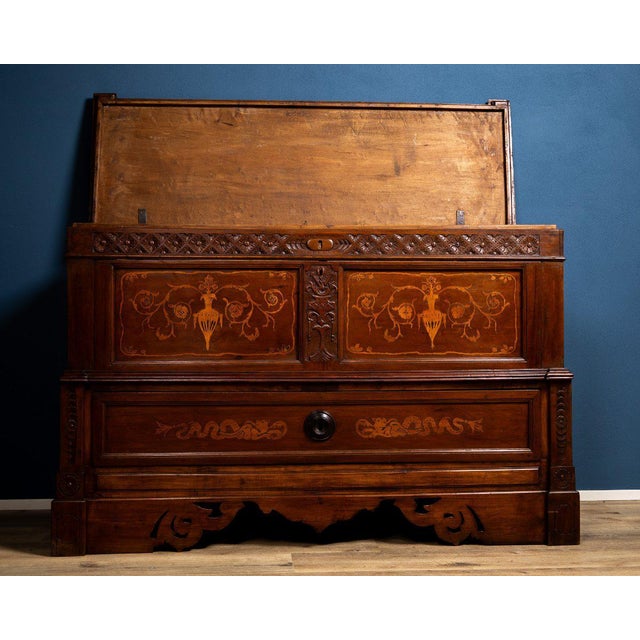 An elegant early 19th-century Emilian sideboard, made of fine cherry wood and enriched with refined decorative inlays. The...