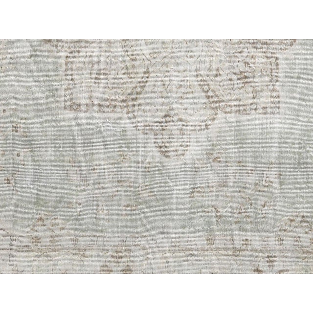 Handwoven wool-on-wool Oushak rug from vintage Turkey, measuring 7'5" x 11'2". Originating from the storied weaving...