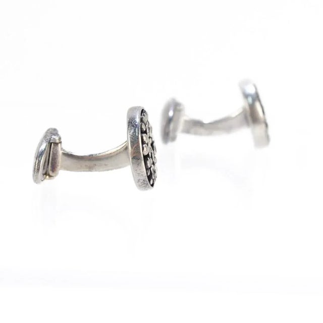 A fine pair of English silver cufflinks. By Links of London. In sterling silver with bezel-set black gemstones. Simply a...