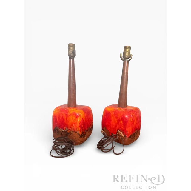 A striking pair of mid-century modern ceramic table lamps attributed to Poole Pottery, featuring richly expressive lava...