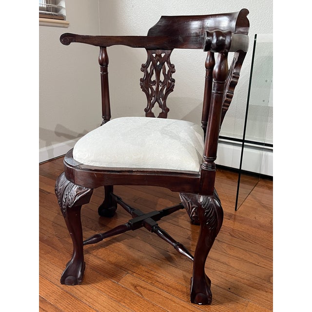 This exquisite Chippendale-style corner chair is crafted from solid mahogany, featuring a rich, dark-stained finish that...