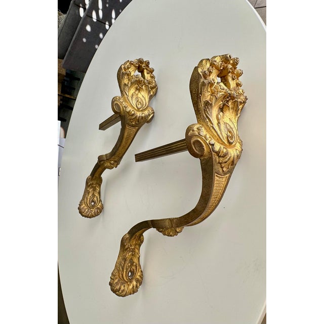 An antique French Louis XVI-style pair of gilt bronze curtain hooks or tie-backs richly decorated with acanthus leaf and...