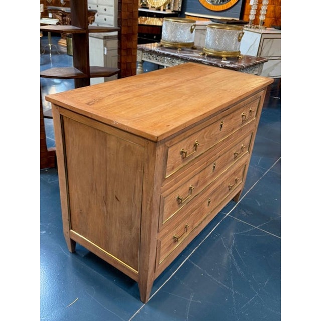 19th century French Directoire' faded walnut and brass trim commode. Circa 1840. A French Directoire-style commode in...