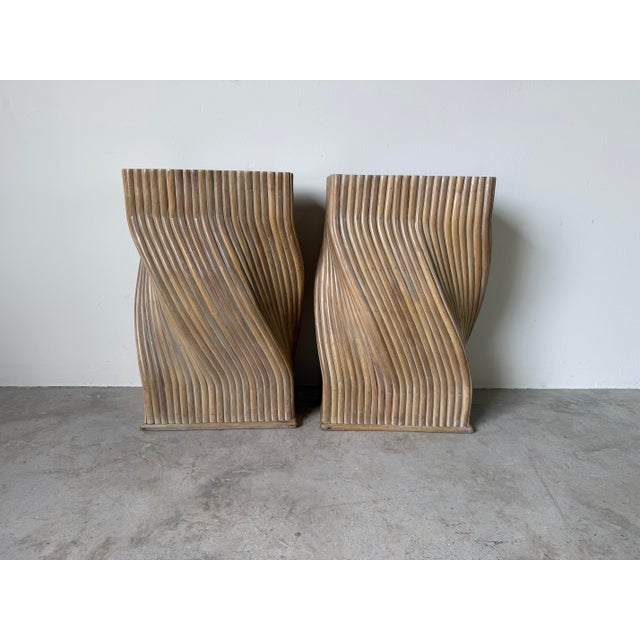 An exceptional pair of vintage sculptural rattan pedestals in the style of McGuire, showcasing a striking twisted...