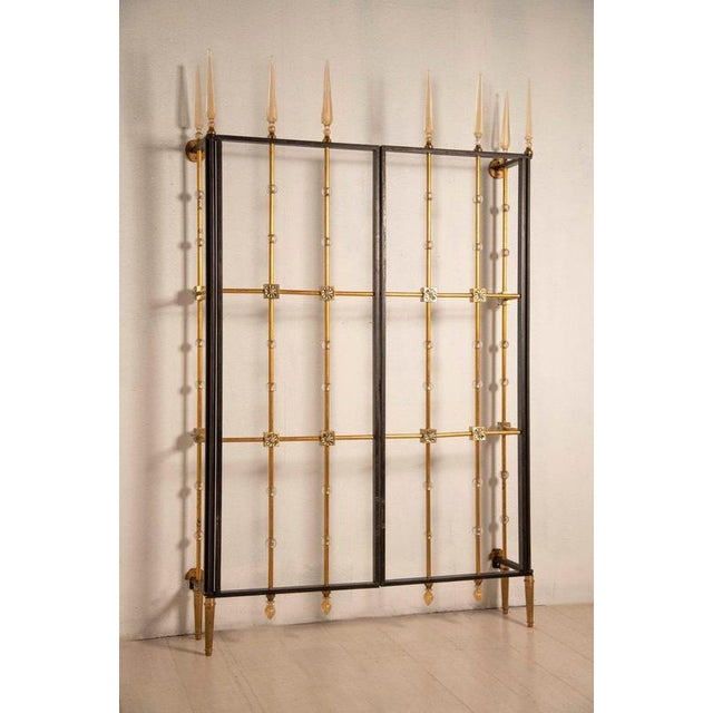 Gate in iron, glass, and brass, designed by andré arbus for expertise, of french origin, dated 1940. A rare and elegant...