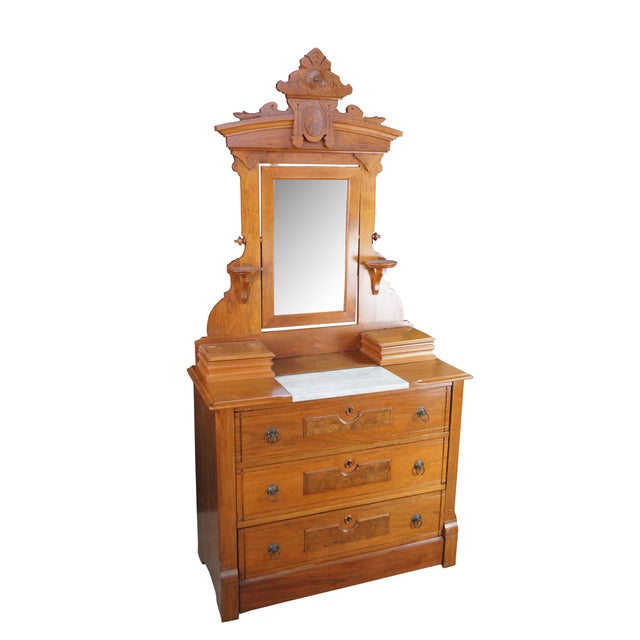 A beautiful Late Victorian Eastlake Dresser and Mirror, circa 1880. The case is made from walnut with three lower drawers...