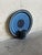 This vintage ceramic chamberstick features a circular wall plaque backing with an attached cylindrical candle cup. The...