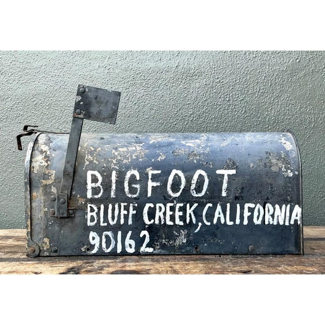 This vintage metal mailbox brings the character of mid-20th-century roadside Americana to a compact, functional object....