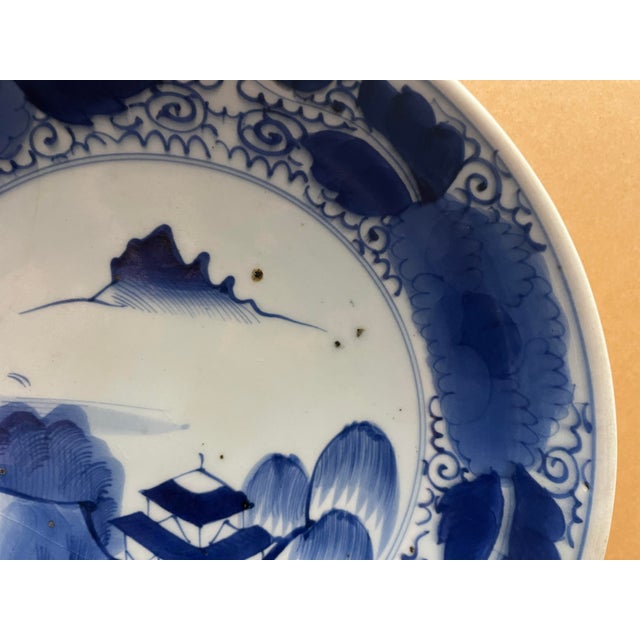 An authentic Japanese Arita porcelain charger dating to the late Edo period (circa 1820–1850). Hand-painted in rich cobalt...