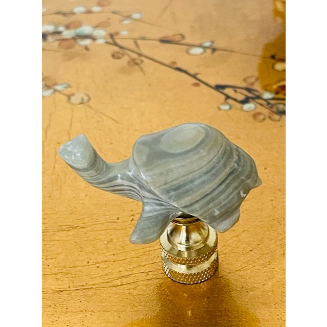 Agate stone with latticino pattern turtle figurine mounted on brass base as lamp finial.