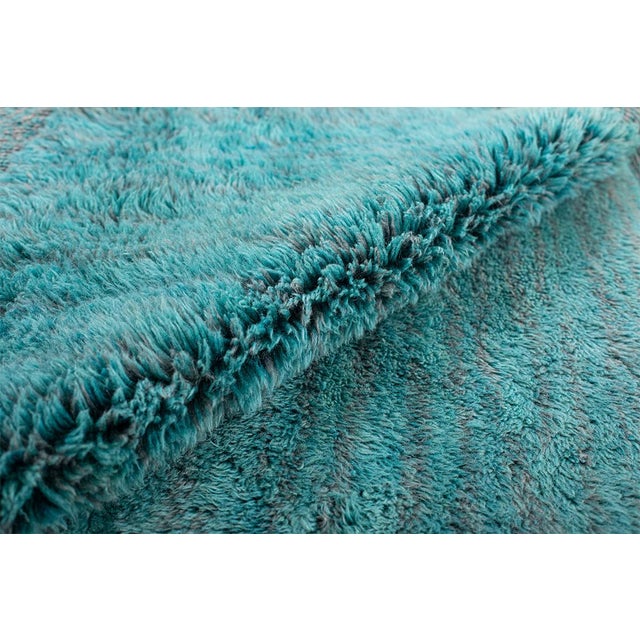 A sophisticated hand-knotted wool rug in calming Teal, Sage Green, Odyssey Grey, Patina Green, Peacock Blue, and Light...