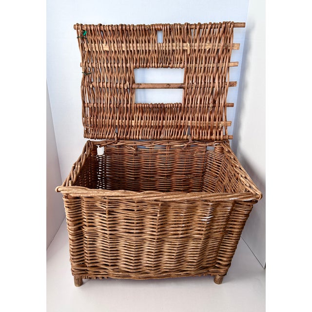 Sturdy, vintage handwoven English basket with lid, blends rustic utility with timeworn character. It's tightly woven...