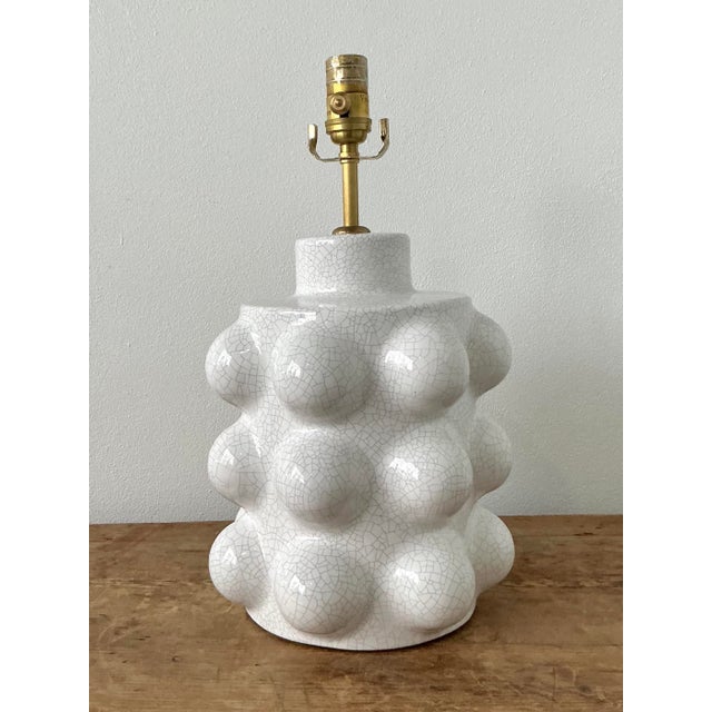 The Visual Comfort "Verdra" table lamp is a striking marriage of Postmodern geometry and organic texture, offering an...