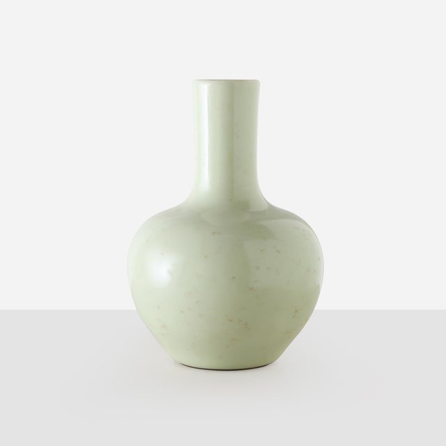 Description Celadon Glaze Long Necked Bottle Vase China, 20th Century A porcelain vase with a soft celadon green glaze,...