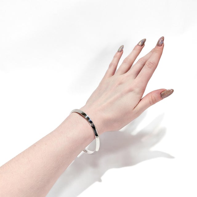 A fine signed Danish Modern bracelet. In sterling silver. By Hans Hansen. Pattern no. 241. With a beveled edge. Marked to...