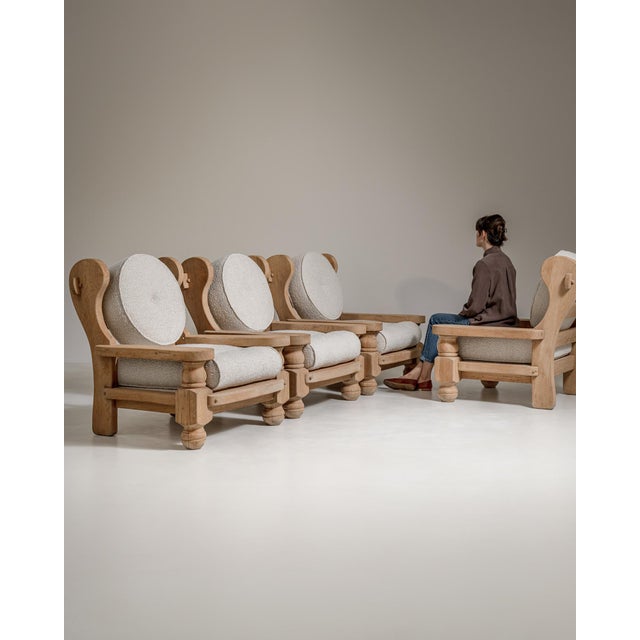 A bold pair of armchairs showcasing the strong geometric forms of the Brutalist movement. The solid oak frames emphasize...