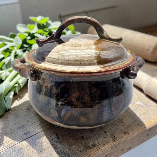 A covered stoneware casserole by California studio potter Benitta Pauly, produced during the late twentieth century studio...