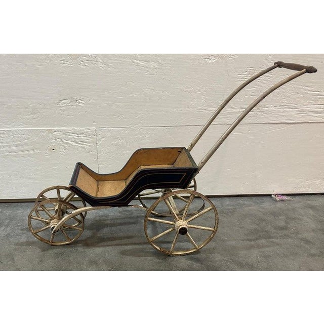 This amazing all original painted and hand made construction doll buggy or carriage and is in fine condition. The...