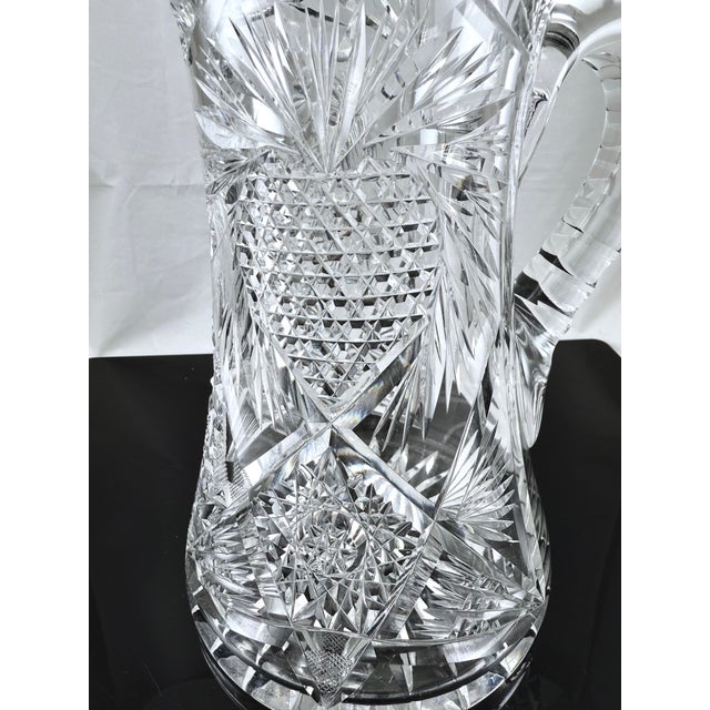 Gorgeous American Brilliant cut glass pitcher. The intricate cutting highlights what is either a heart or strawberry. The...