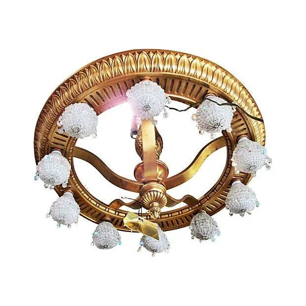 Unique, French Louis XVI bronze doré wheel chandelier, featuring lovely patina on the gold gilding and ten under-mount...