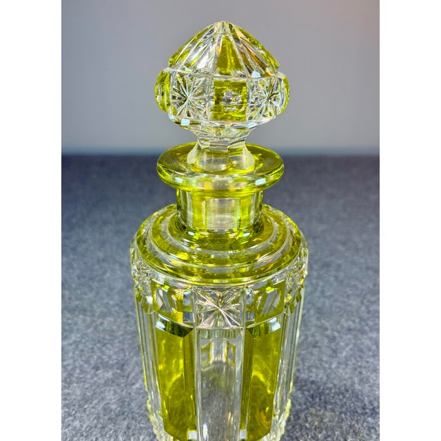 Beautiful cut crystal glass perfume bottle with stopper featuring a yellow art-deco style ribbon/panel design.