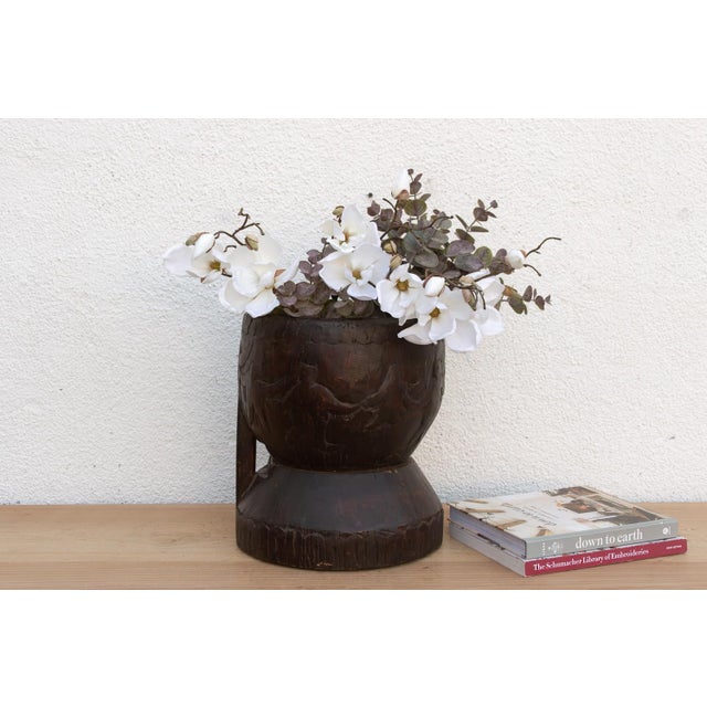 This dramatic vessel is a genuine piece of Primitive Treenware and Tribal Art, transforming a functional grain or spice...