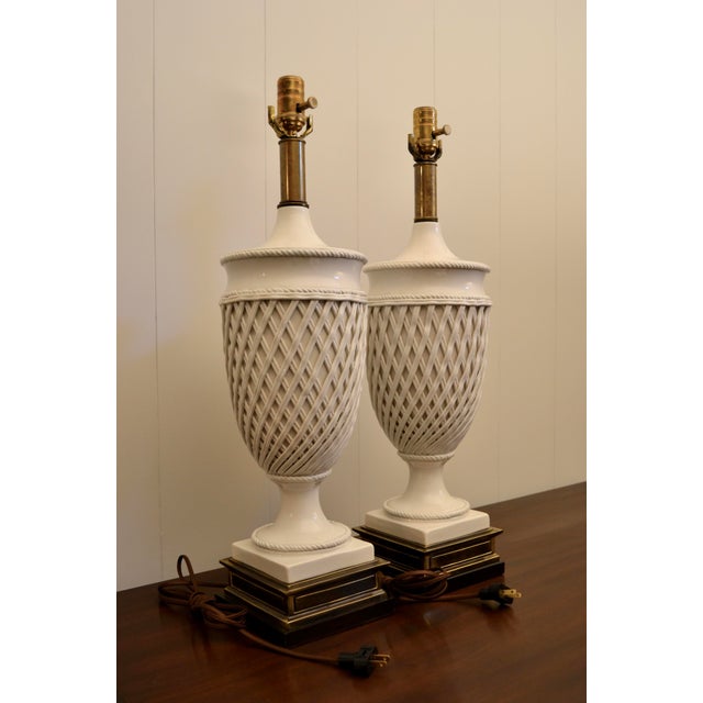 A pair of notable lamps designed by Frederick Cooper. Monumental creamware urn forms with intricate reticulated...