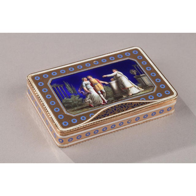 Rectangular enamelled gold box. The hinged lid is decorated with a scene of young people dressed in neoclassical clothing...
