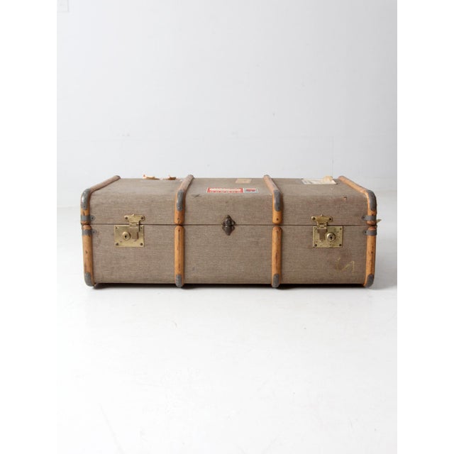This 1950s steamer trunk is a timeless travel relic, featuring its original Cunard Line and transit labels. With a rigid,...