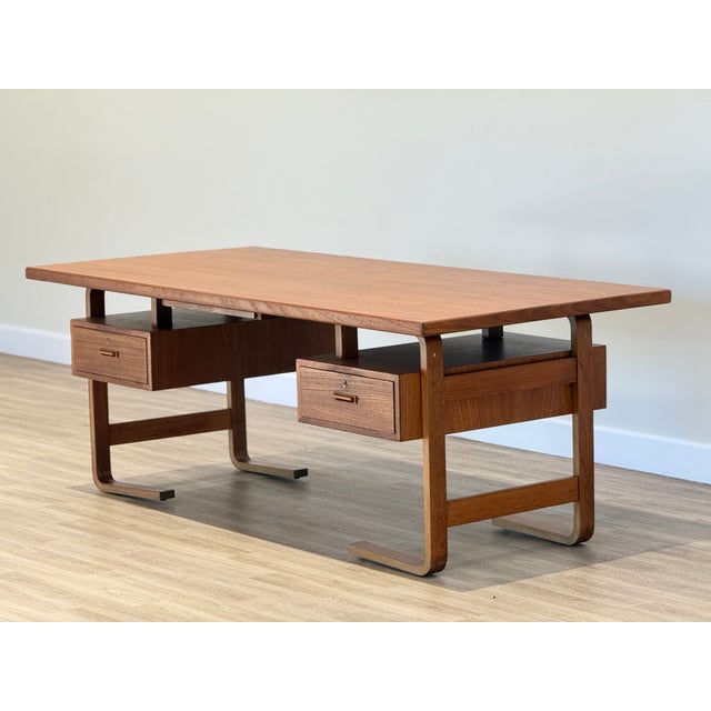 A commanding presence of quiet authority, this exceptional executive desk by jørgen clausen, crafted for brande...