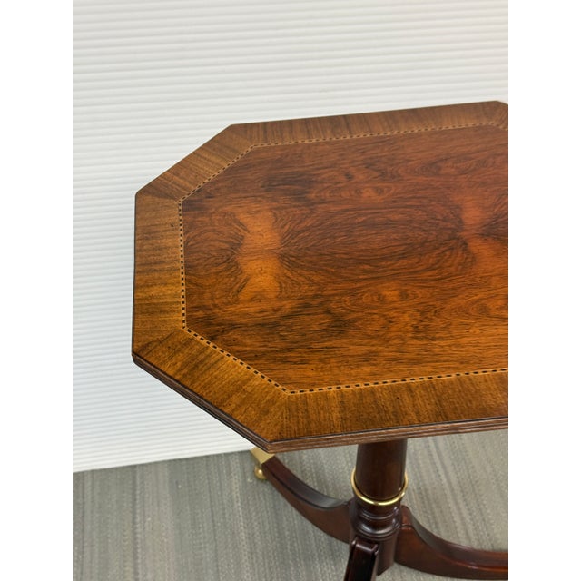 Design Plus Gallery presents a Tilt-Top Satin Wood Side Table from Baker Furniture. The interesting tilt-top side table...