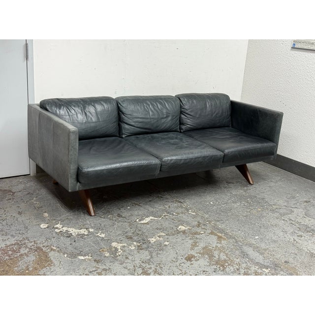 Design Plus Gallery presents the Brooklyn Leather Sofa from West Elm. The sofa offers solid oak + engineered hardwood...