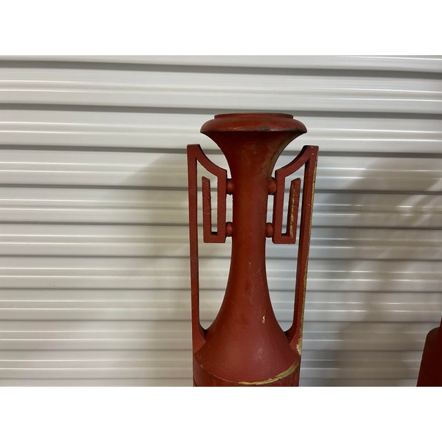 Pair of French Art Deco Iron Urns. This gorgeous pair of French Art Deco urns with Greek key handles are the perfect...