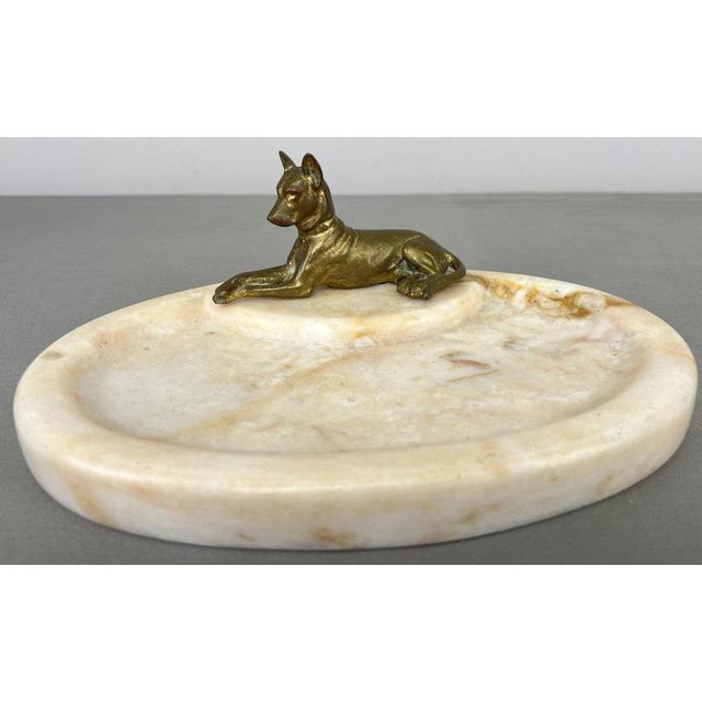An elegant Antique marble tray featuring a decorative brass dog figure positioned on a raised section at one end,...