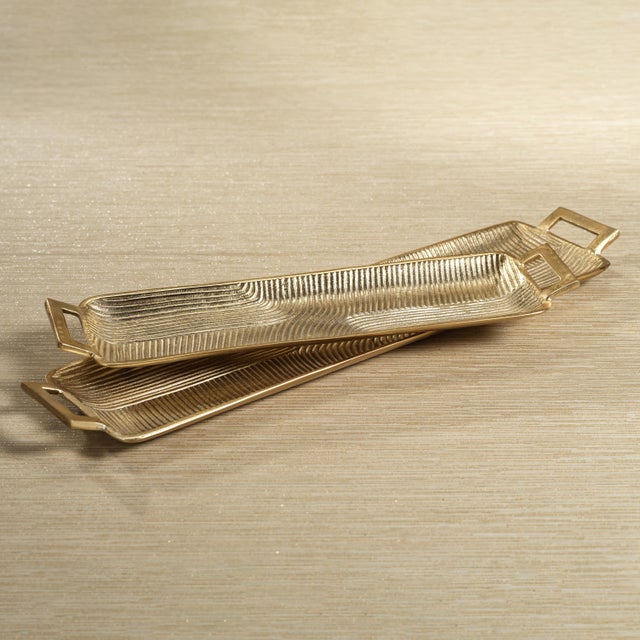 Decorate a console or coffee table with this textured rectangular tray. Made from aluminum with open side handles, this...