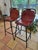 Pair of barstools in the manner of French architect, Charlotte Perriand. Black enameled steel & brown leather. France, c....