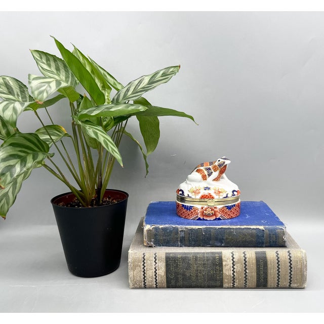 Exquisite vintage porcelain trinket box by Andrea by Sadek, crafted in the tradition of classic Limoges-style hinged...