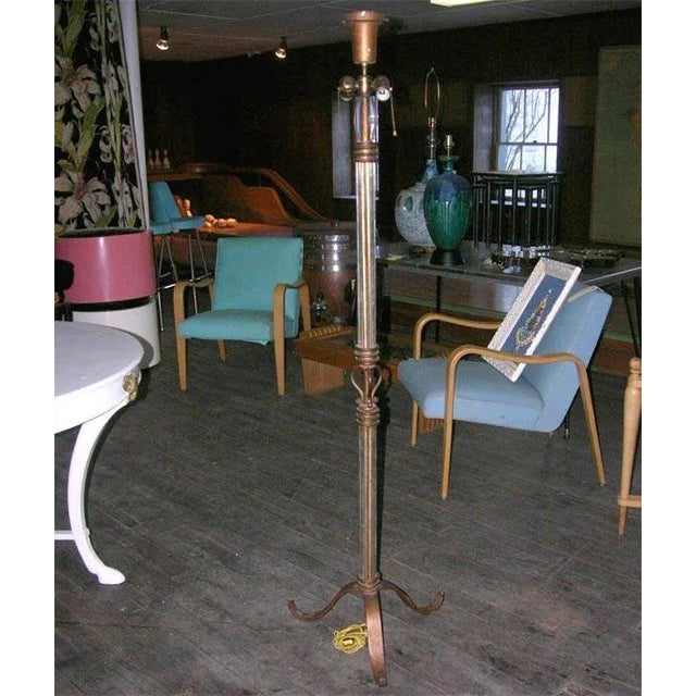 Gilt wrought iron with tubular glass rods and tripod base floor lamp from France.