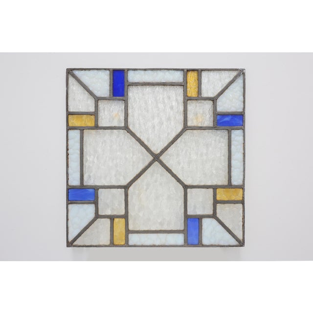 A striking Belgian Art Deco leaded glass panel dating from the 1920s, distinguished by its balanced geometric composition...
