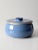 This is a vintage studio pottery covered bowl. Signed by the artist, the handmade ceramic jar features a bright sky blue...